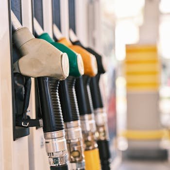 Close-up shot of colorful gas pump nozzles at a fuel station, emphasizing variety and choice.